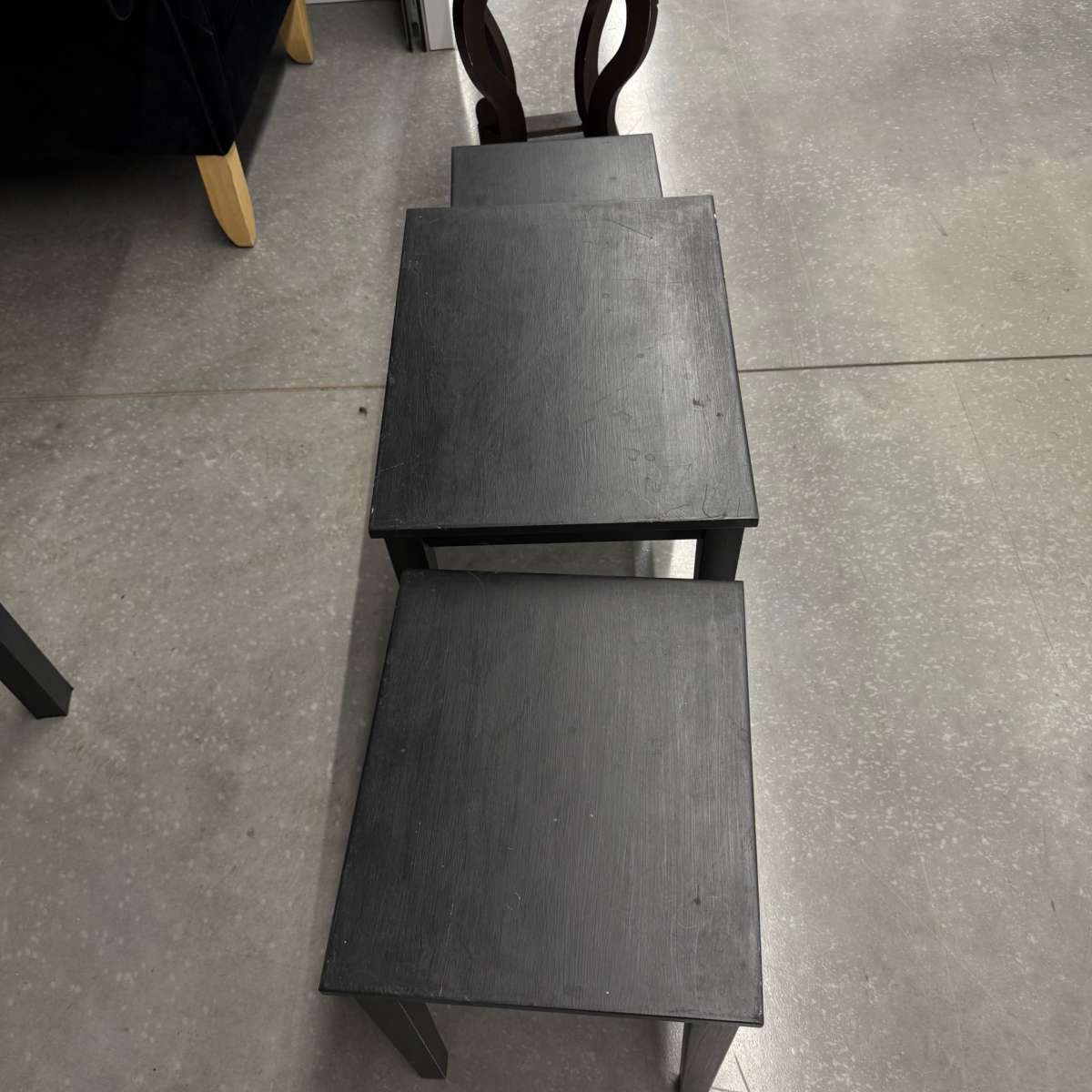 3 black tables slide under the other for easy storing used