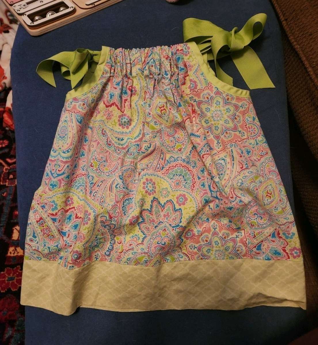 Girl dress with green ribbon straps