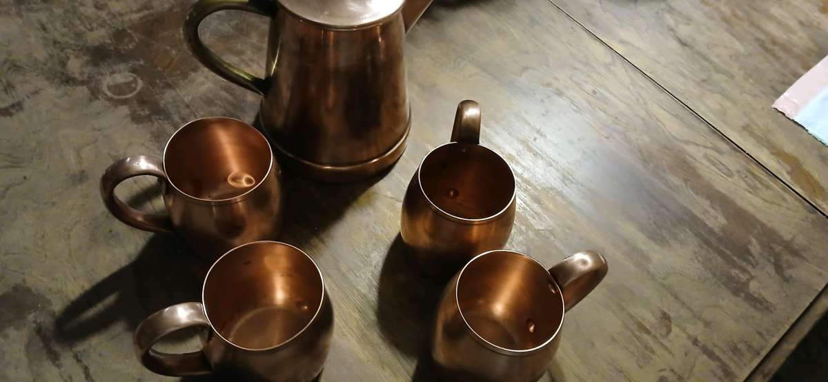solid copper cups and a coffee pot