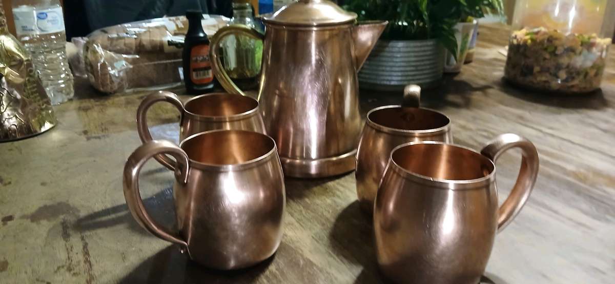 solid copper cups and a coffee pot