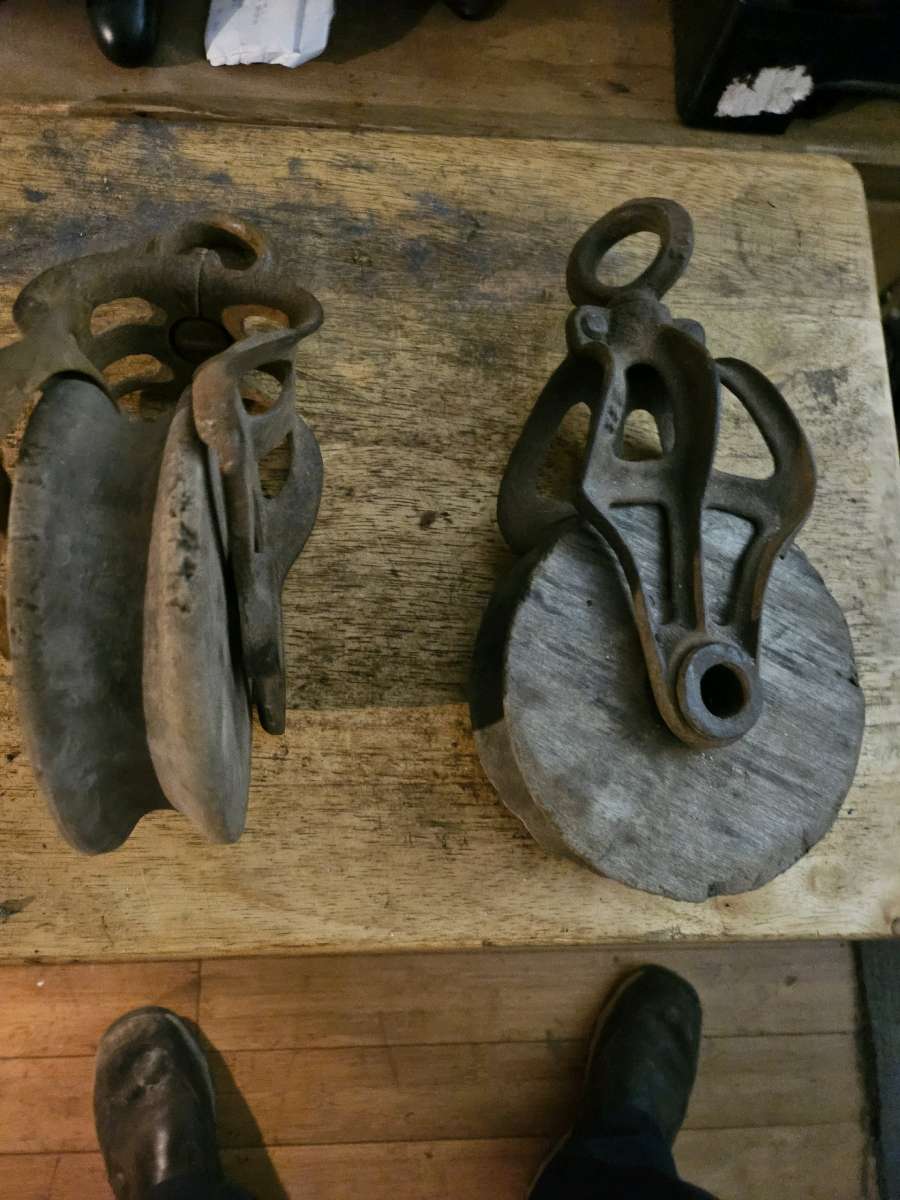 2 old wooden pulleys with metal frames 10 dollars for both