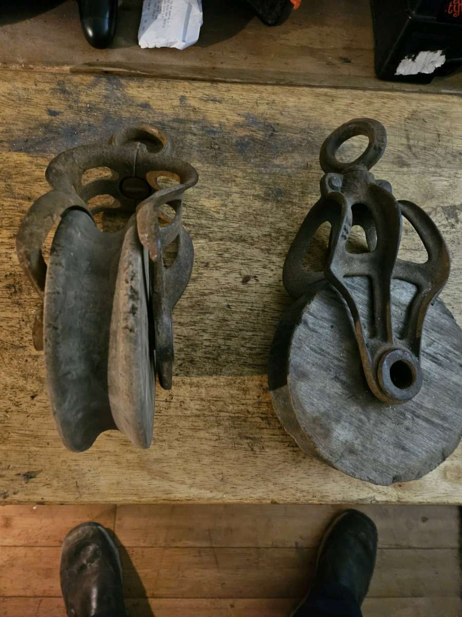 2 old wooden pulleys with metal frames 10 dollars for both