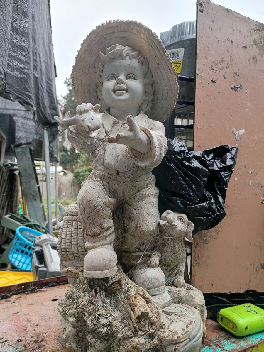 cement boy with his dog