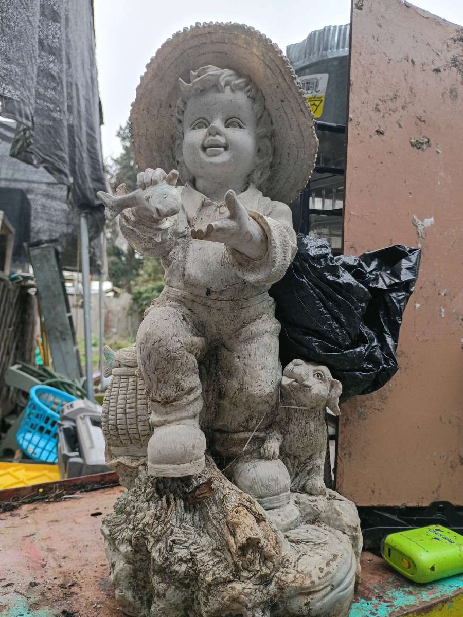 cement boy with his dog