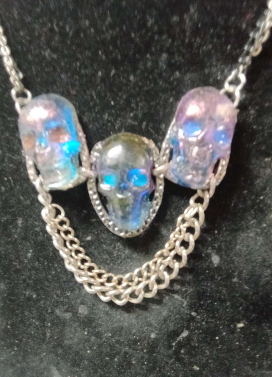three skulls with multiple chains made with Uv resin