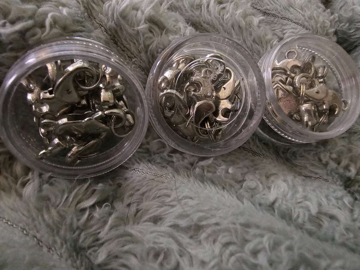 3 small containers of elephant clasp