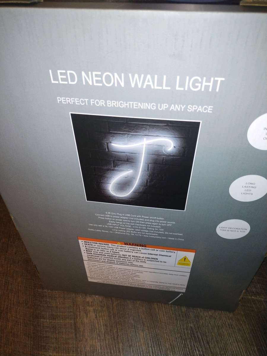 a neon light up j sign  brand new