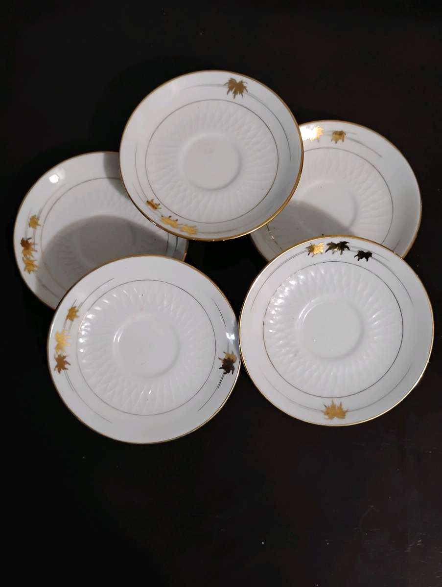 Set of 5 white with gold trim teacup saucers