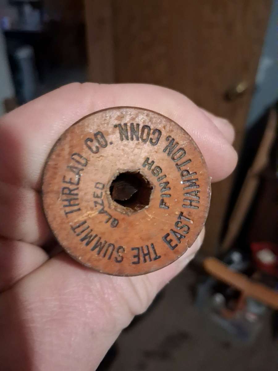 wooden thread spool 1930s has stamps on top