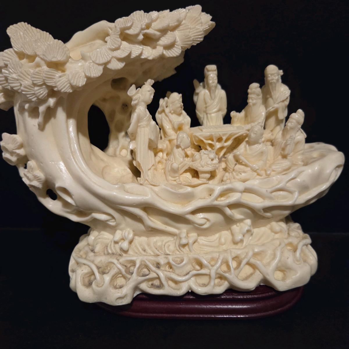 Detailed chinese sculpture with figures and ornate desi