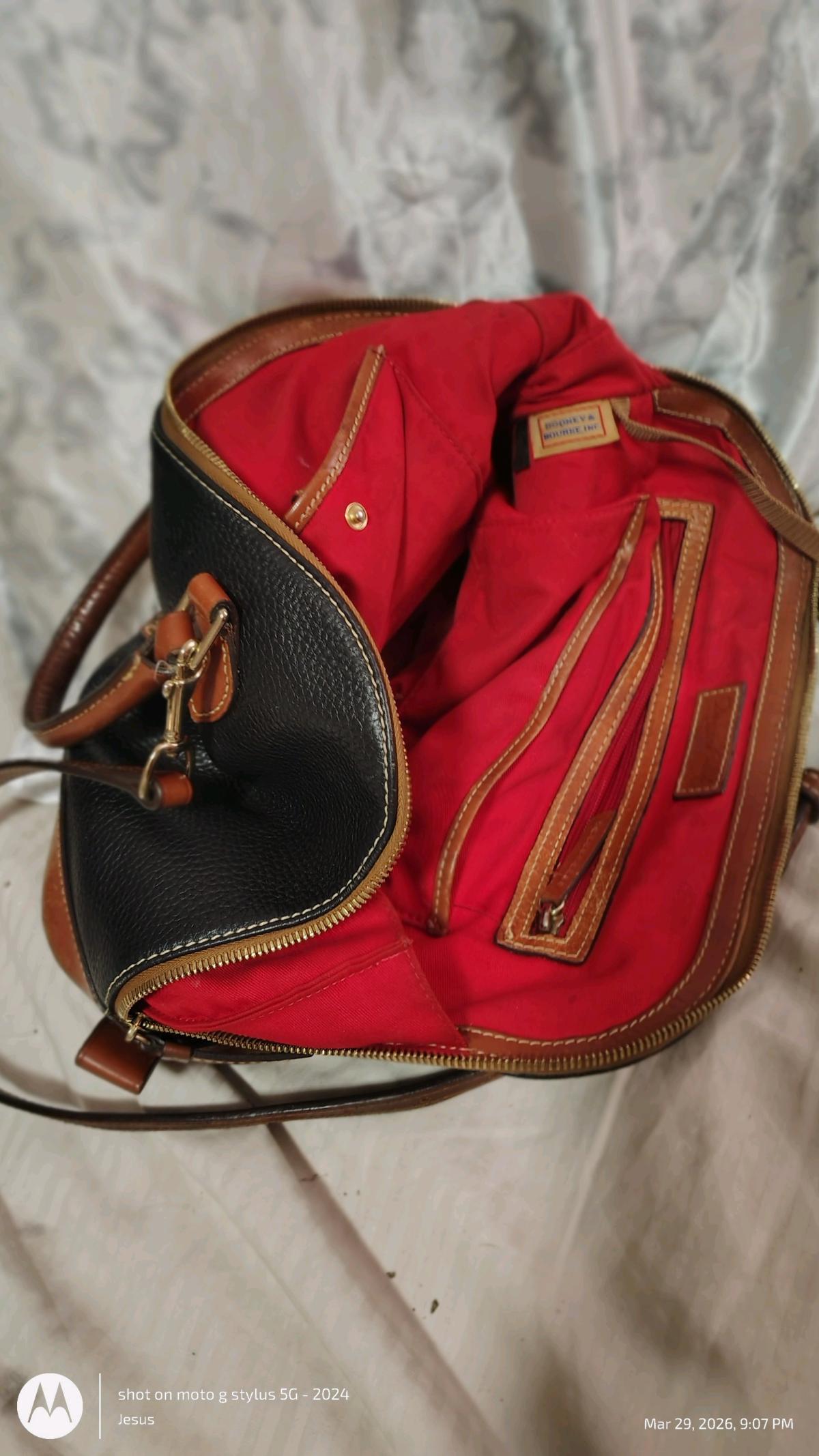 Dooney and Burke black purse with red in lining