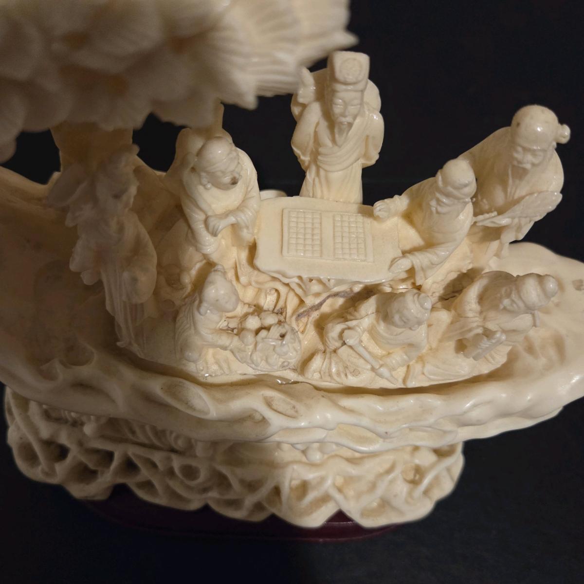 Detailed chinese sculpture with figures and ornate desi