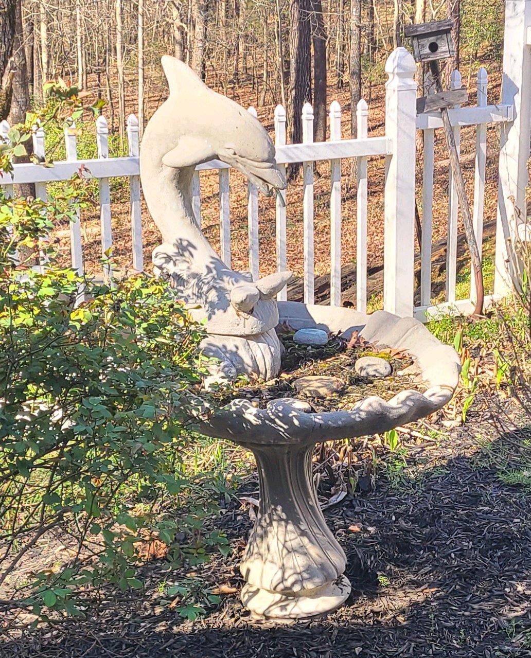 concrete bird bath with dolphin sprinkler