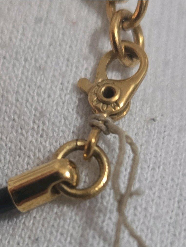 Monet Gold Tone Leaf Pendant Necklace on Black Cord