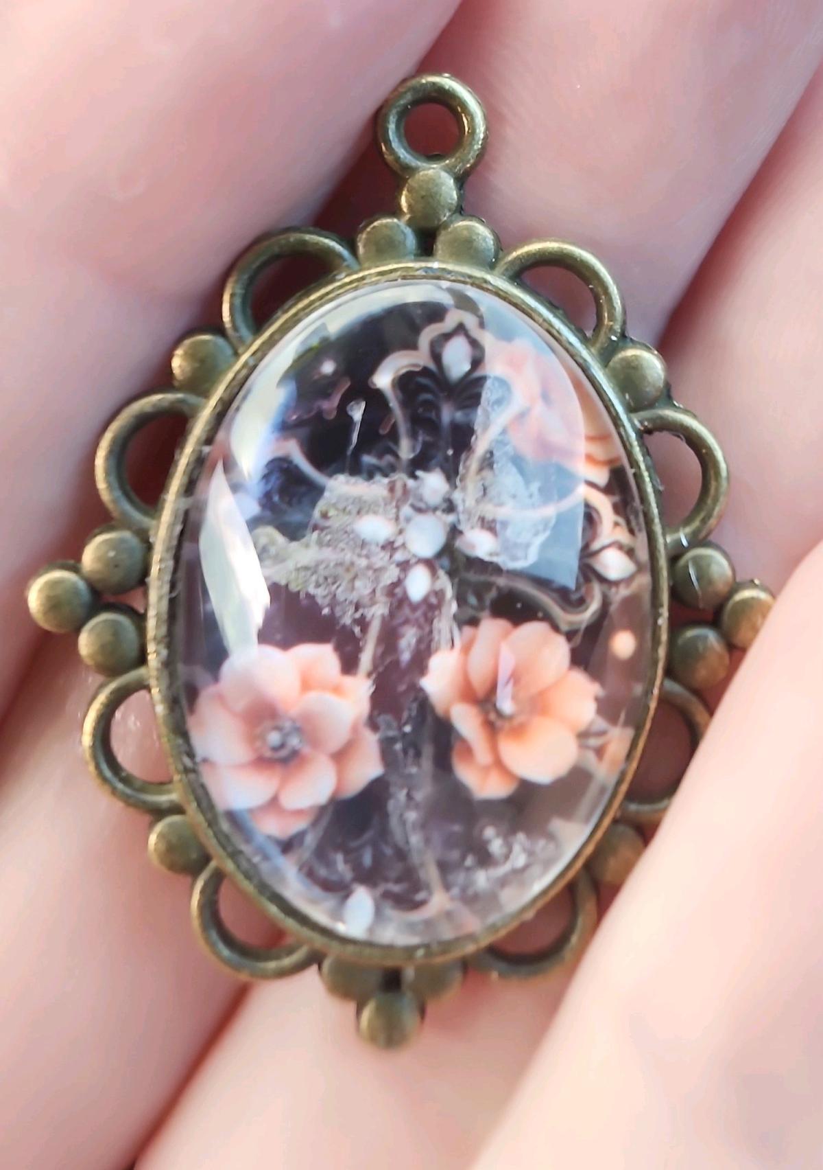 haunted cross picture in a pendant