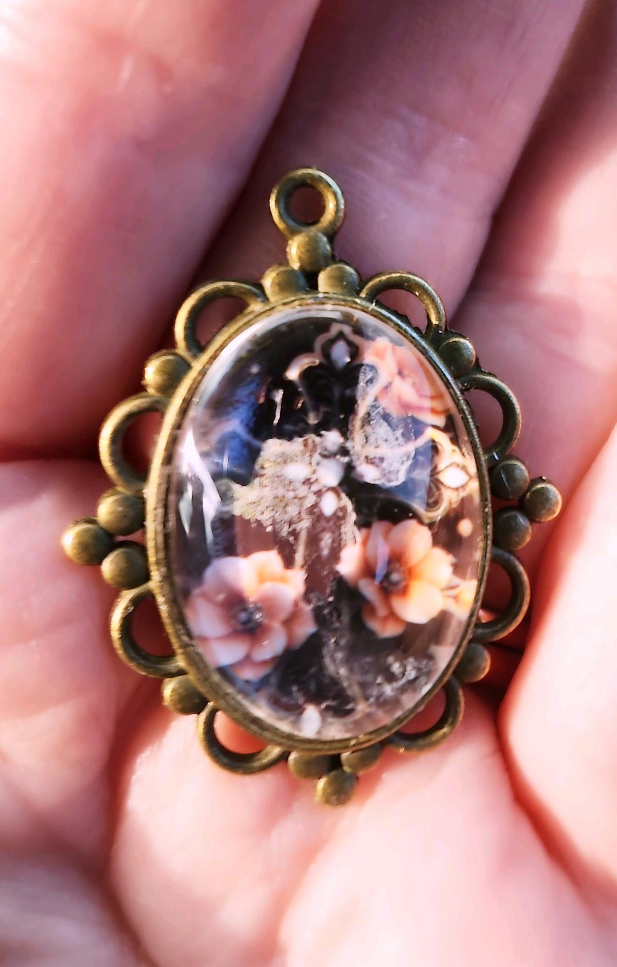 haunted cross picture in a pendant