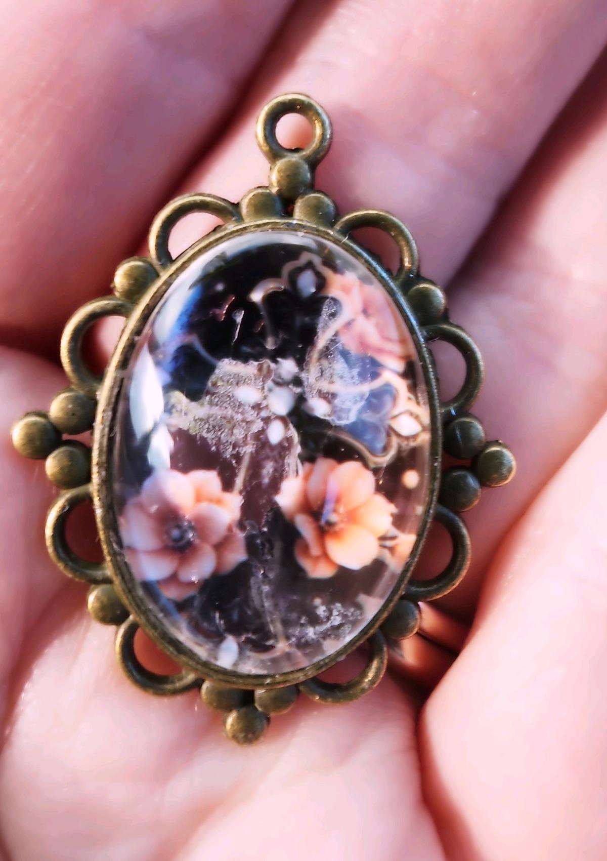 haunted cross picture in a pendant