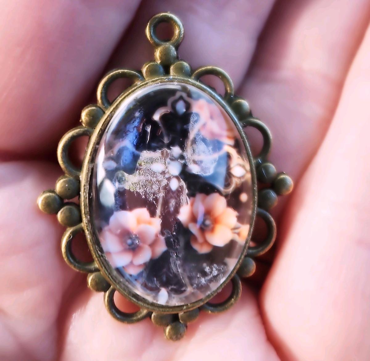 haunted cross picture in a pendant
