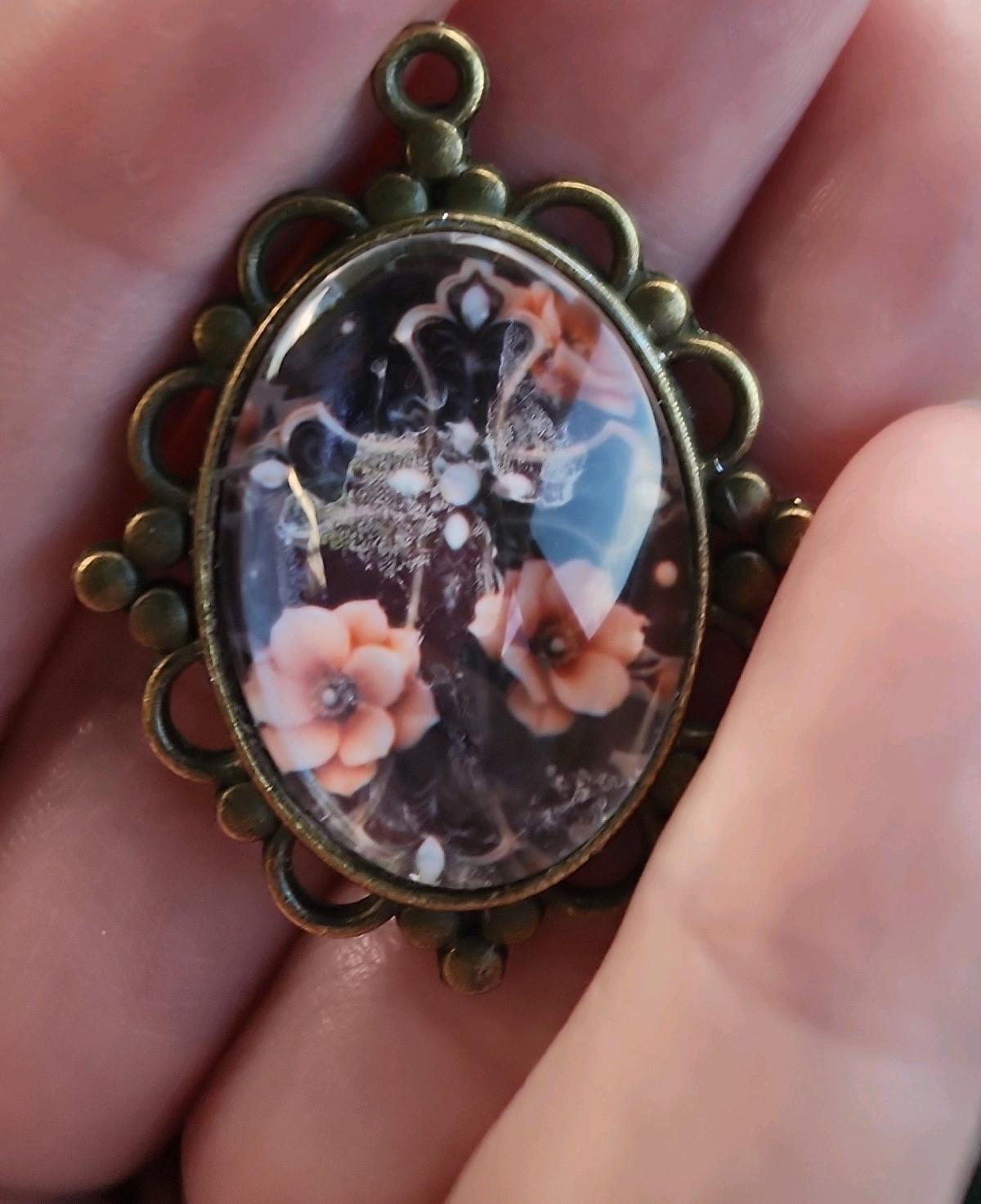 haunted cross picture in a pendant