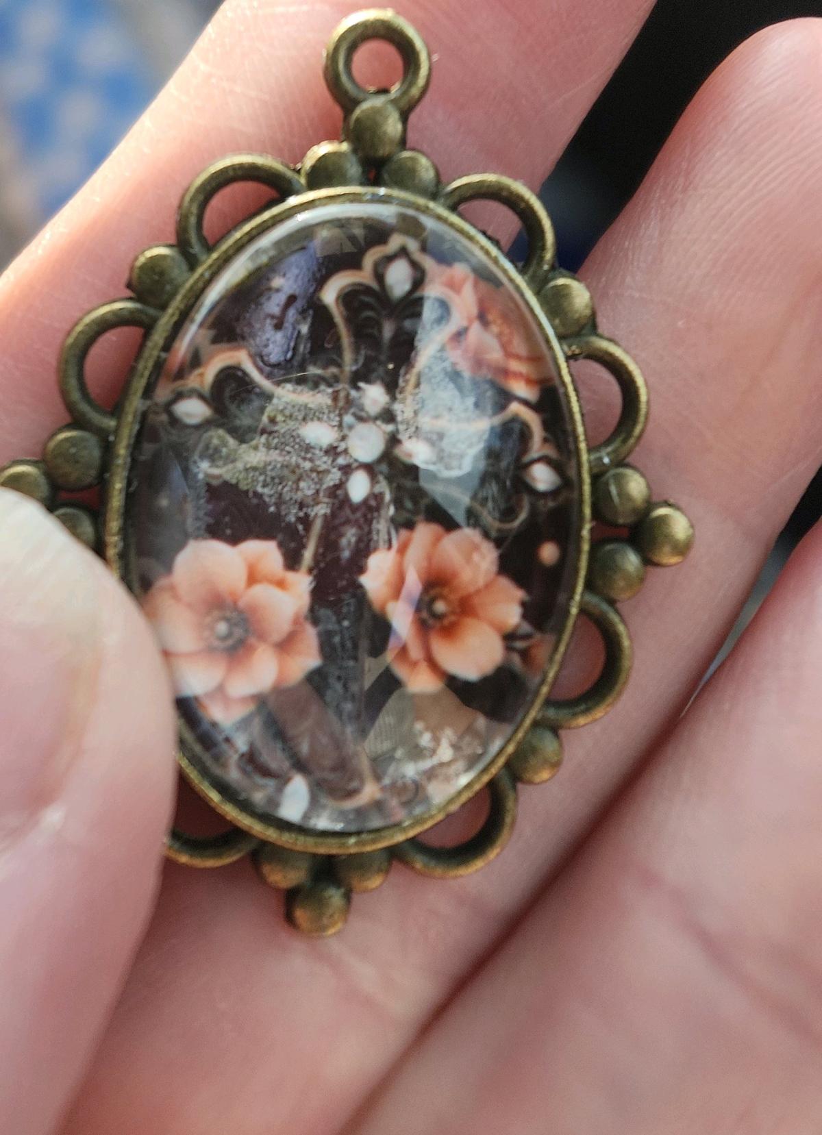 haunted cross picture in a pendant