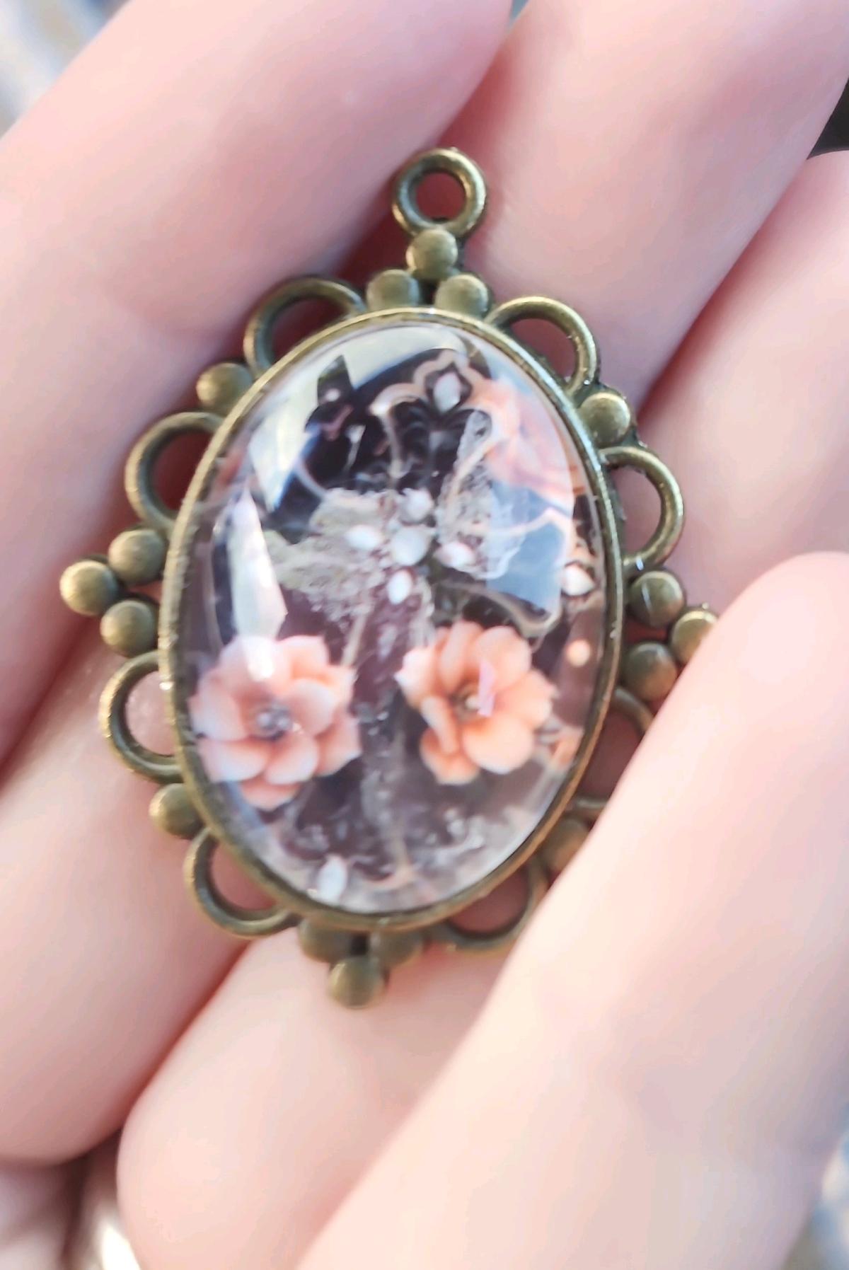 haunted cross picture in a pendant