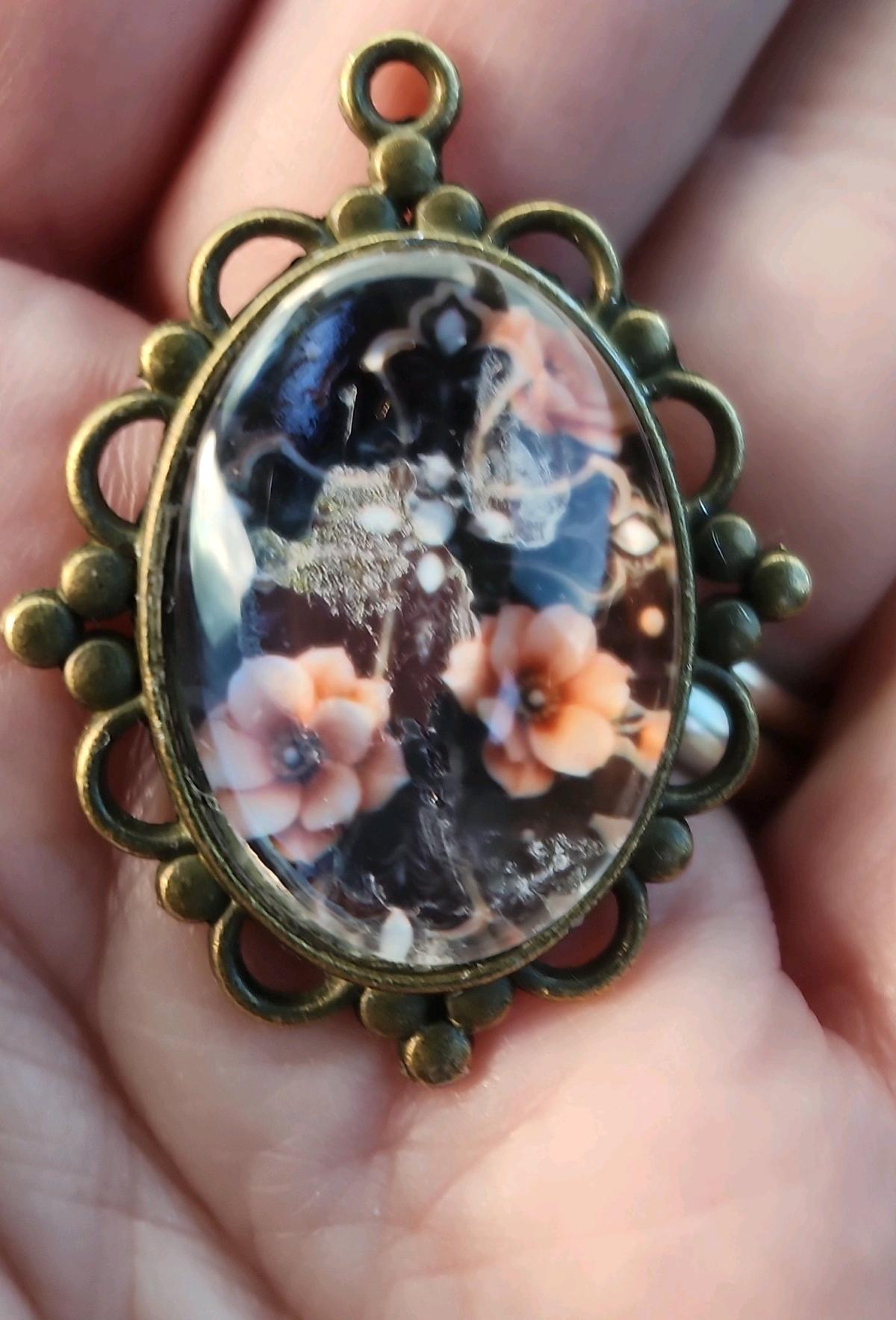 haunted cross picture in a pendant