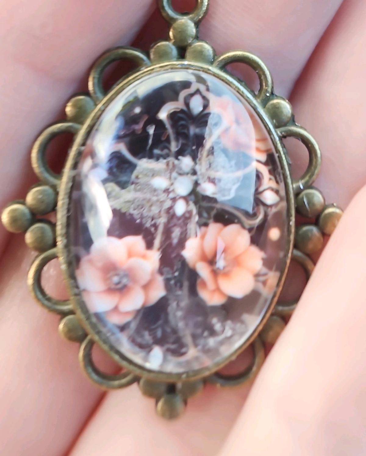 haunted cross picture in a pendant