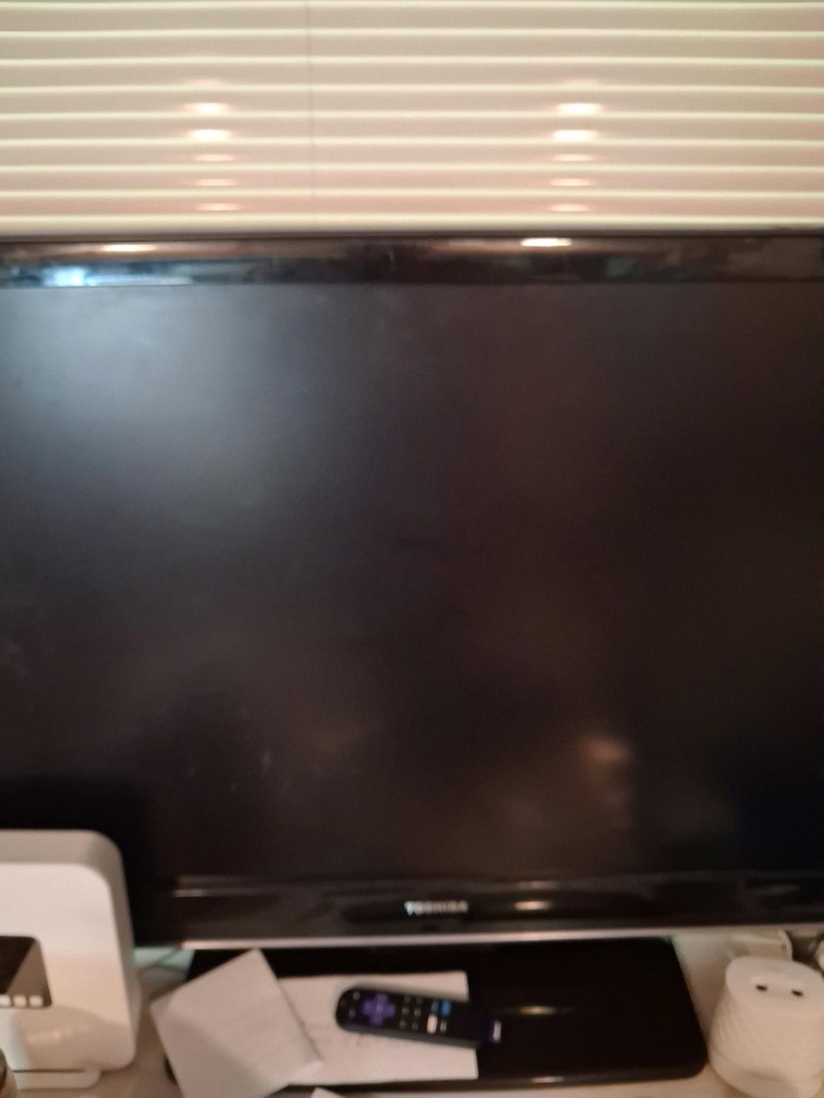 swirl around flat screen TV with roku remote and roku adapte