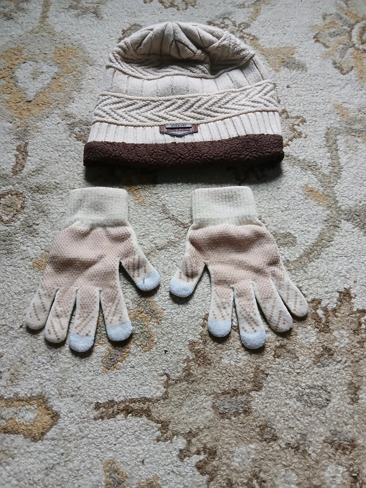 A cozy knit beanie hat and matching gloves The hat has a tex