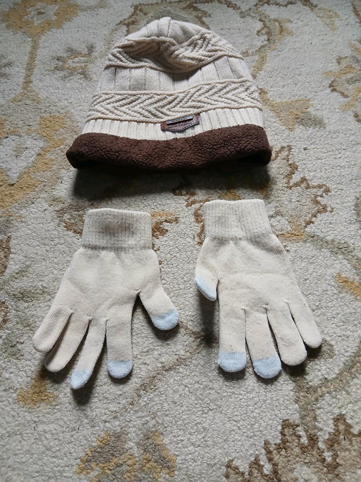 A cozy knit beanie hat and matching gloves The hat has a tex