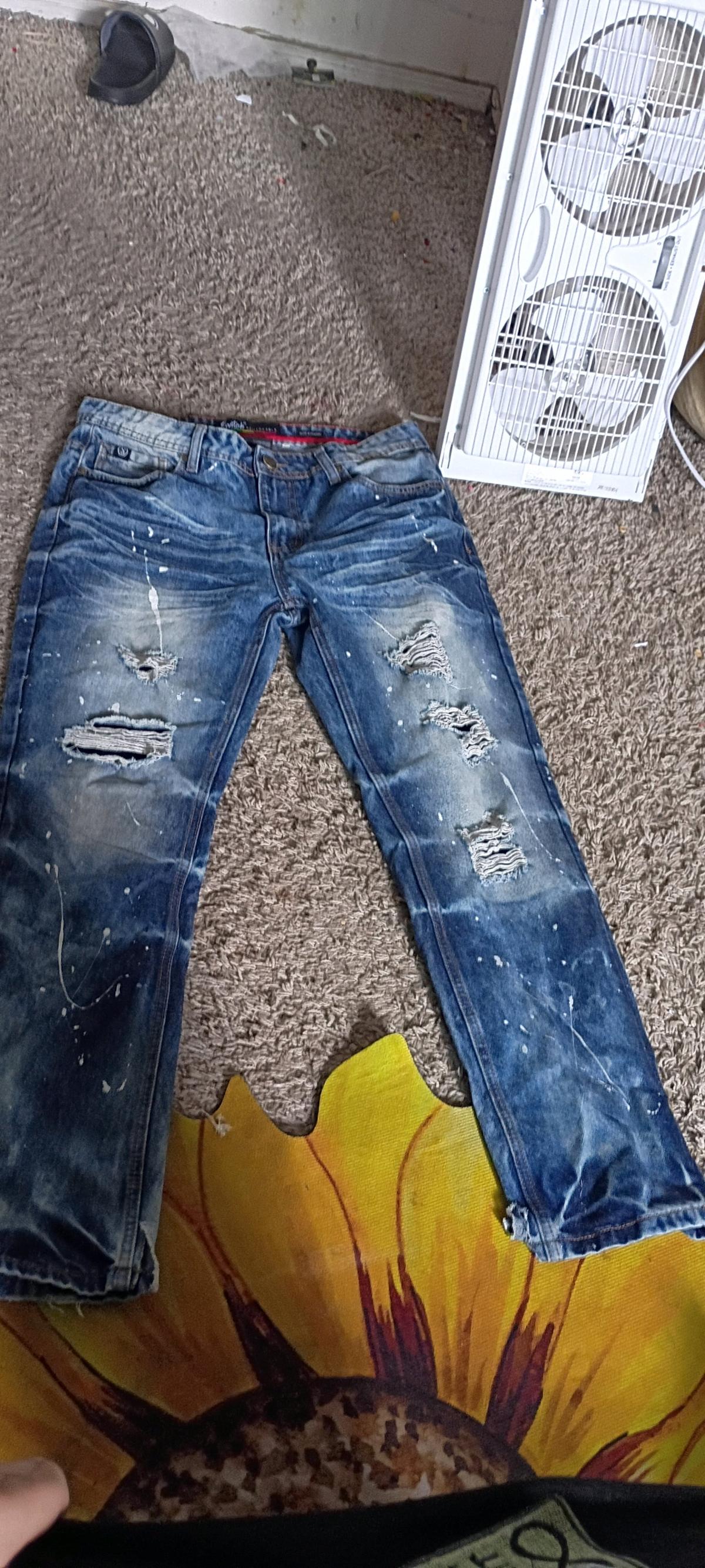 blue ripped jeans w paint splashes