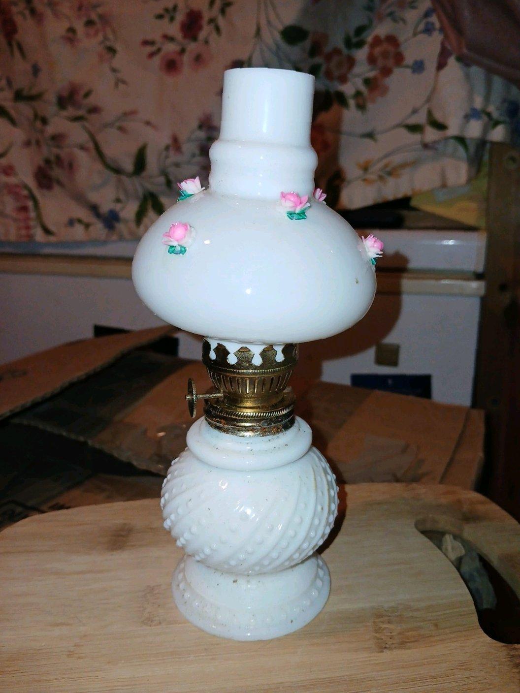 This vintage white with roses around the top oil burner