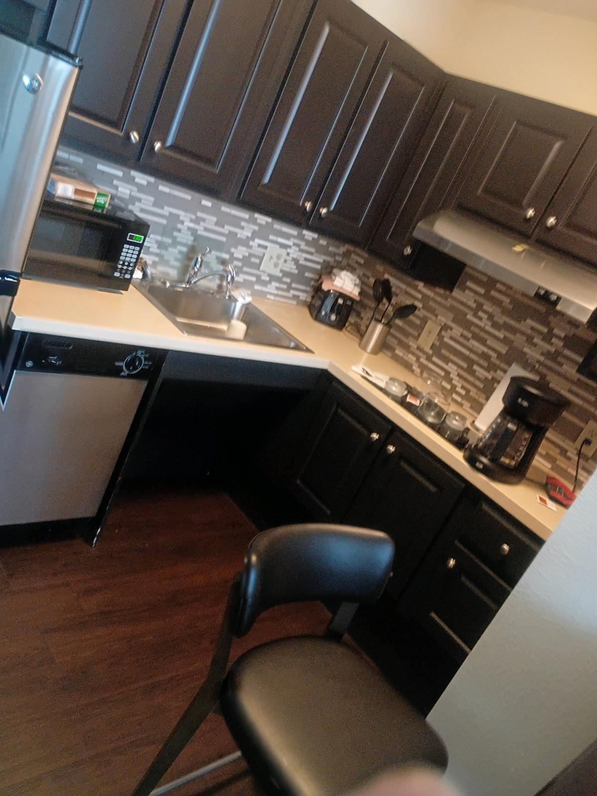 double oven with vent hood and countertop stove and dishwash