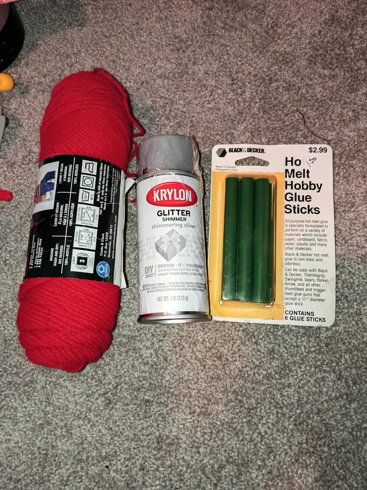 red yarn silver shimmer spray paint and Hot glue sticks