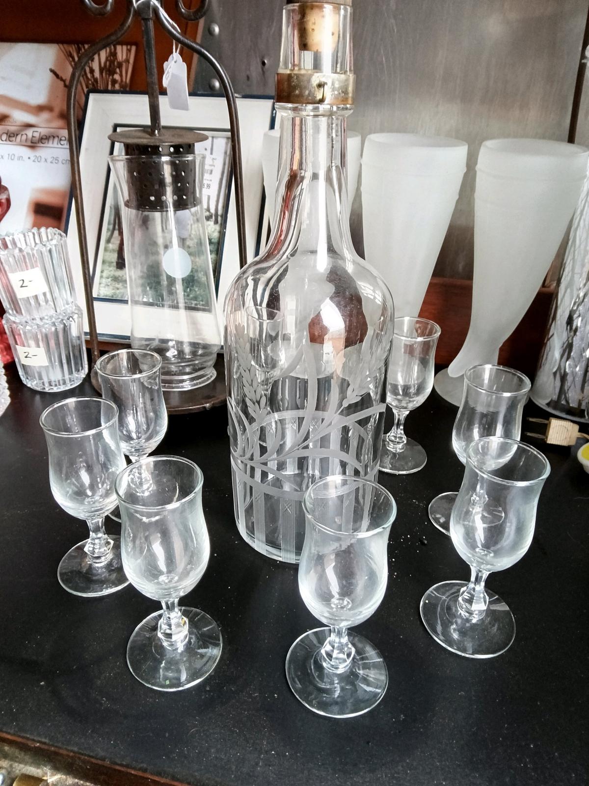 Bottle with etched glass and shot glasses