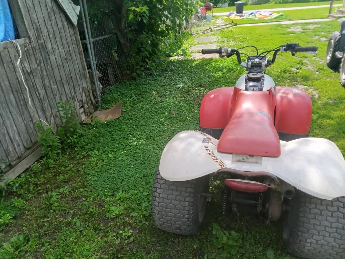 1985 red and white Honda four tax fourwheeler
