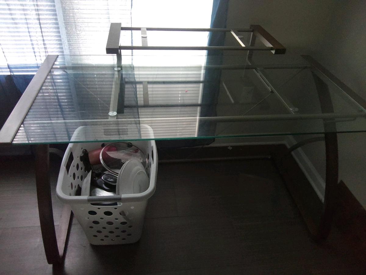 A glass office desk  could be used for a computer desk for h