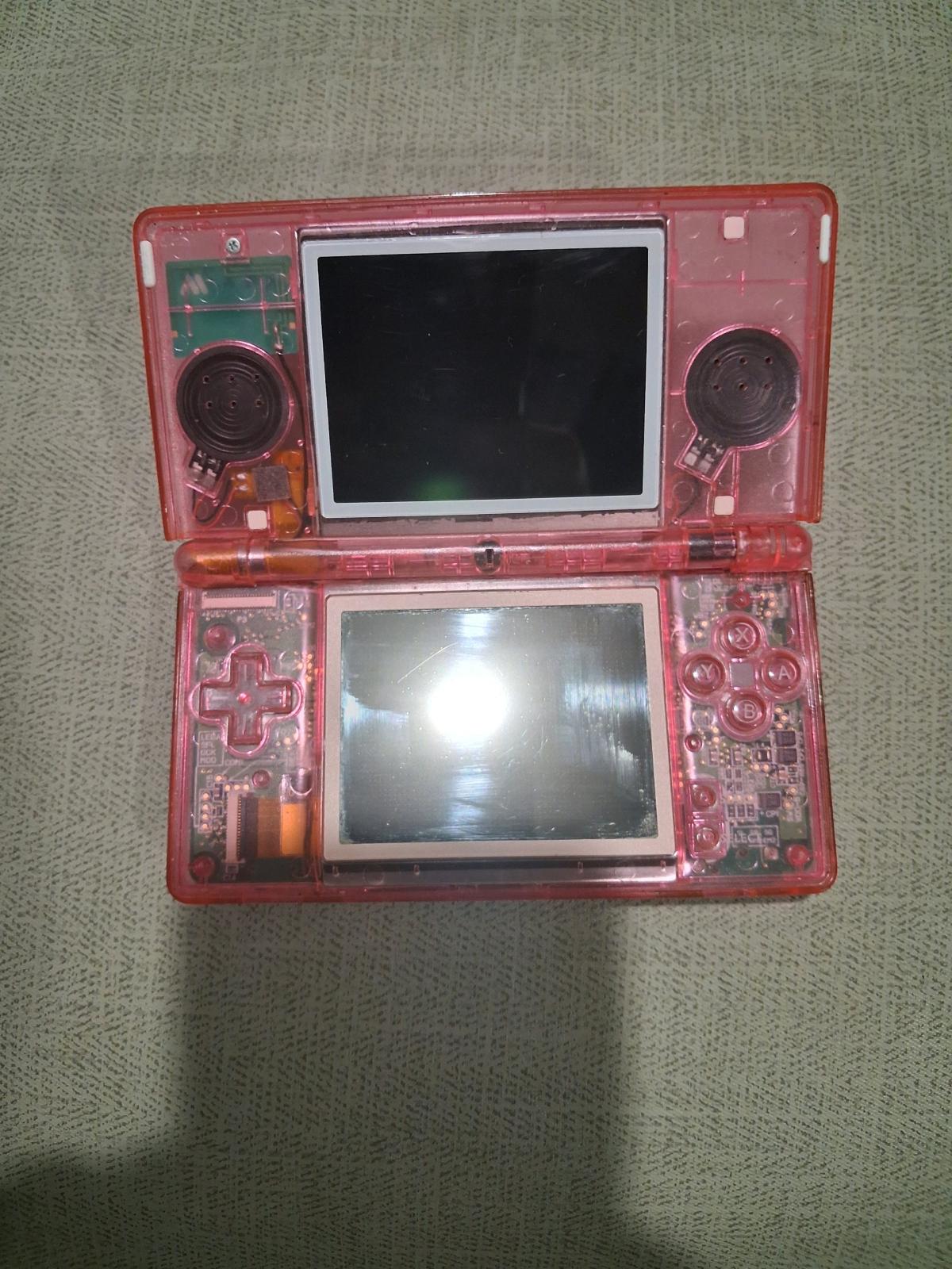 pink transparent Nintendo nes lite with 32gb memory card