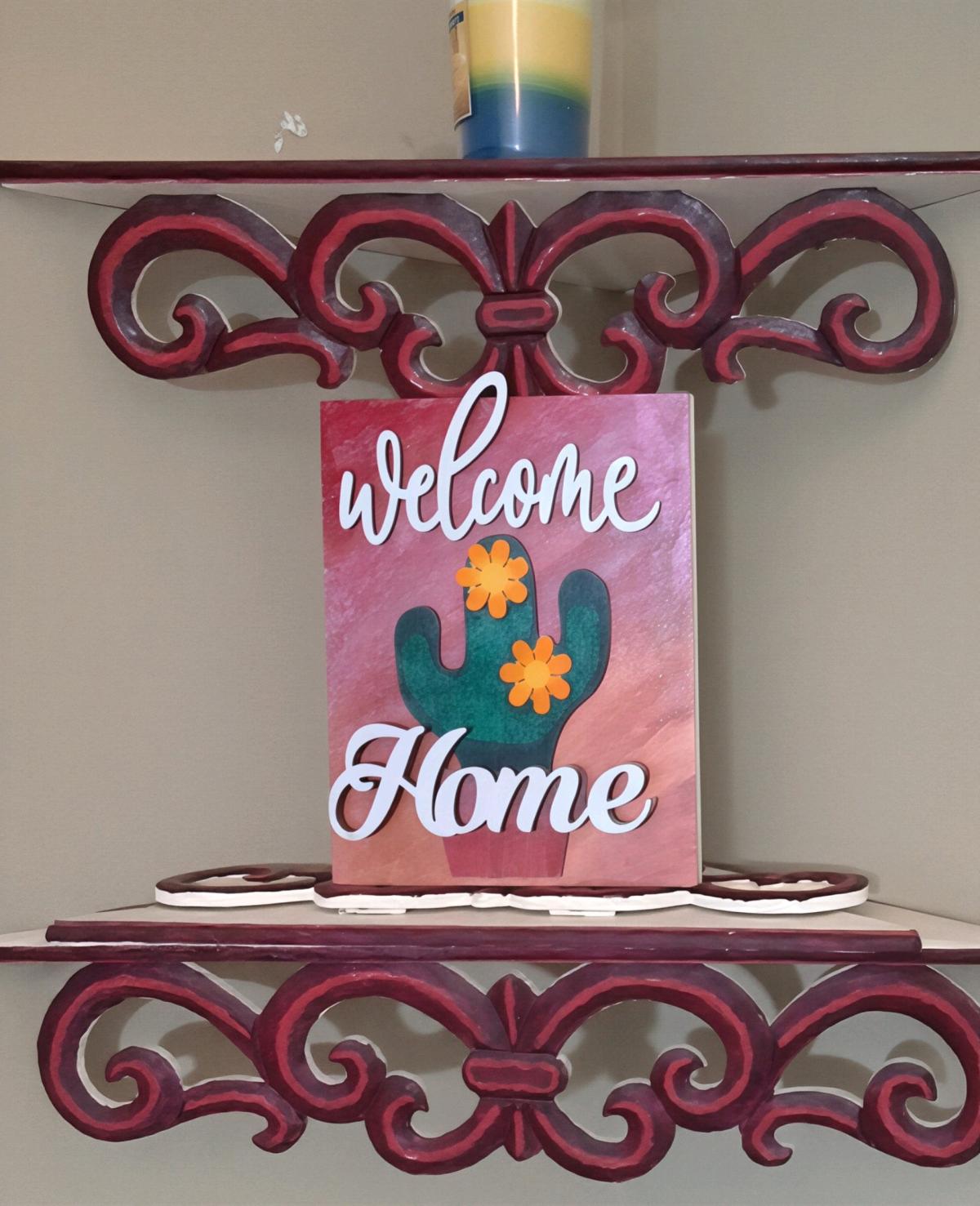 wood welcome home sign with cactus desert sunset