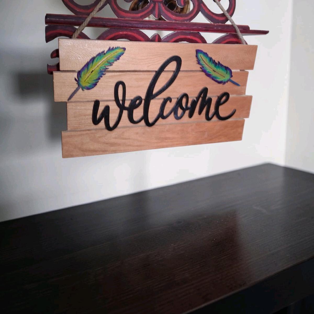 wood welcome sign handmade with feathers