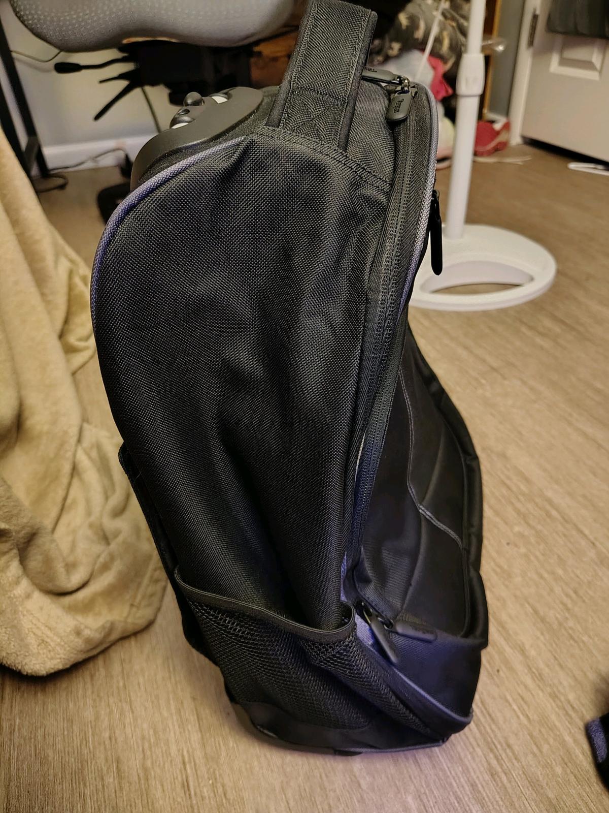 black rolling backpack and a purple non rolling backpack