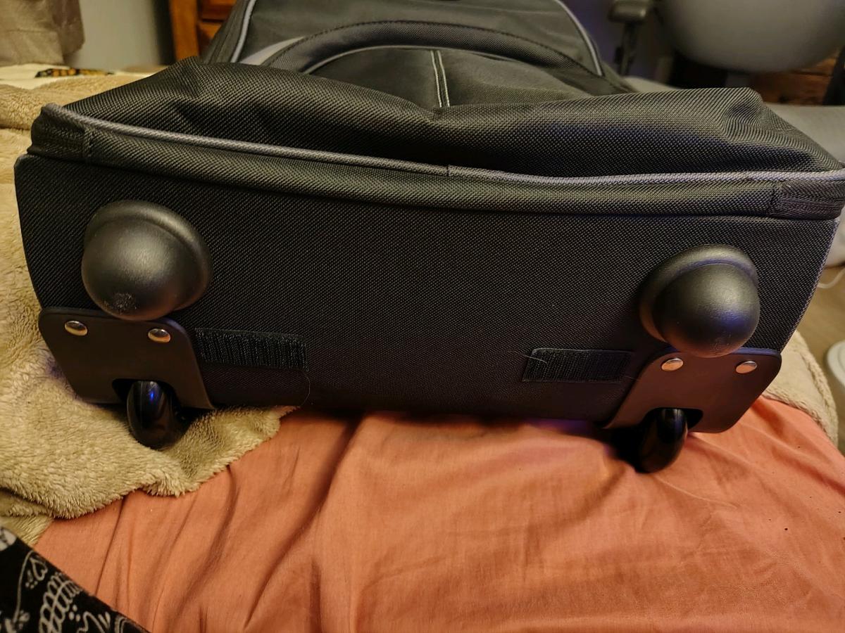 black rolling backpack and a purple non rolling backpack