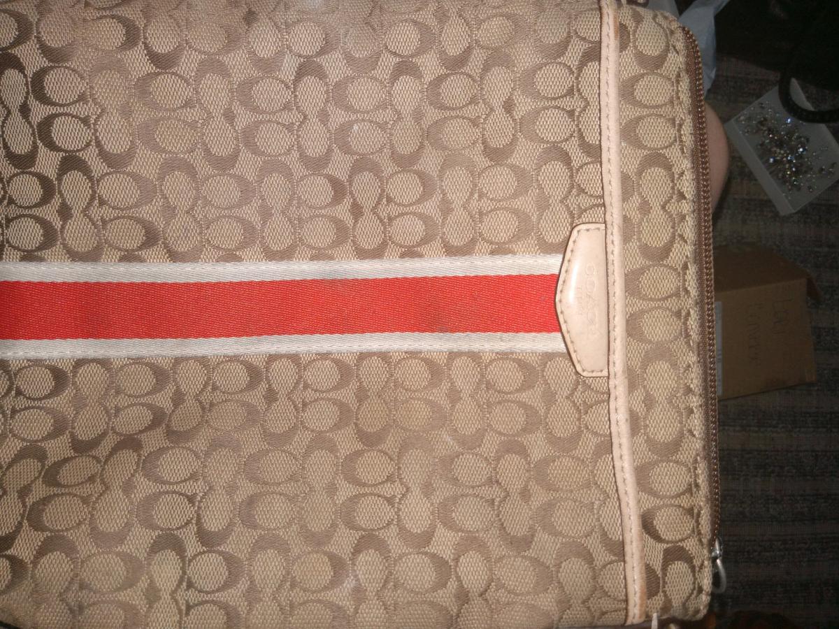 This Coach Signature Stripe bag features a beige jacquard