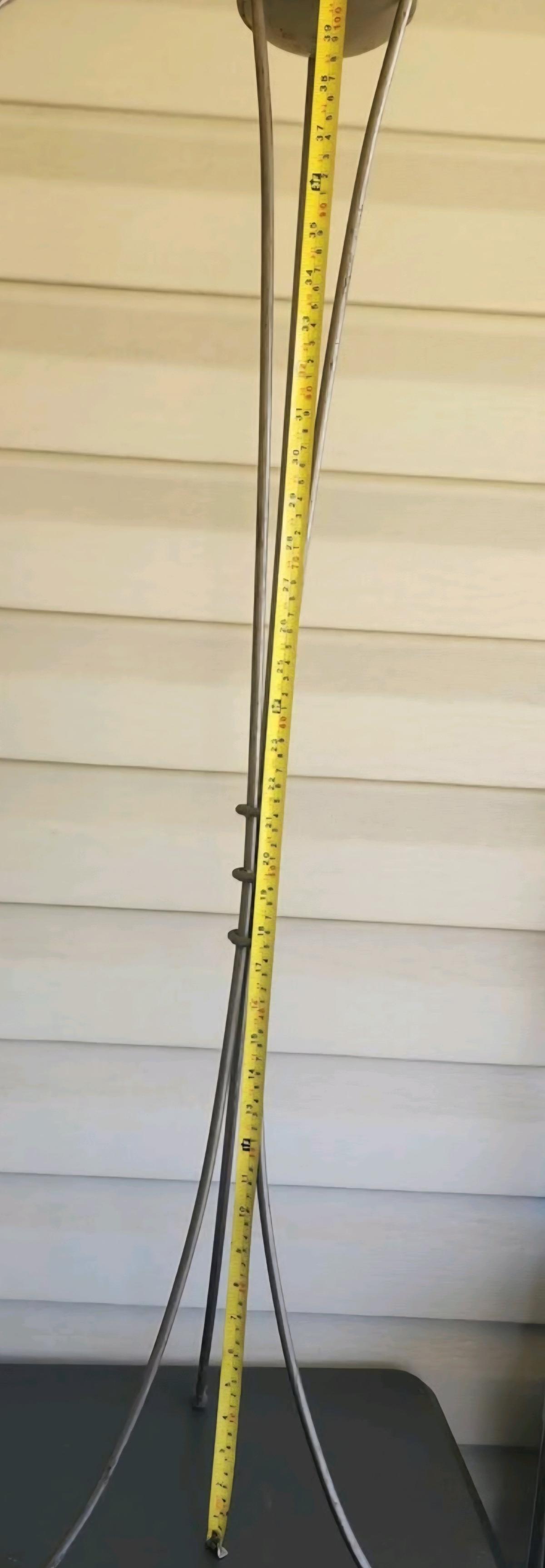 Tall slender metal candle stand