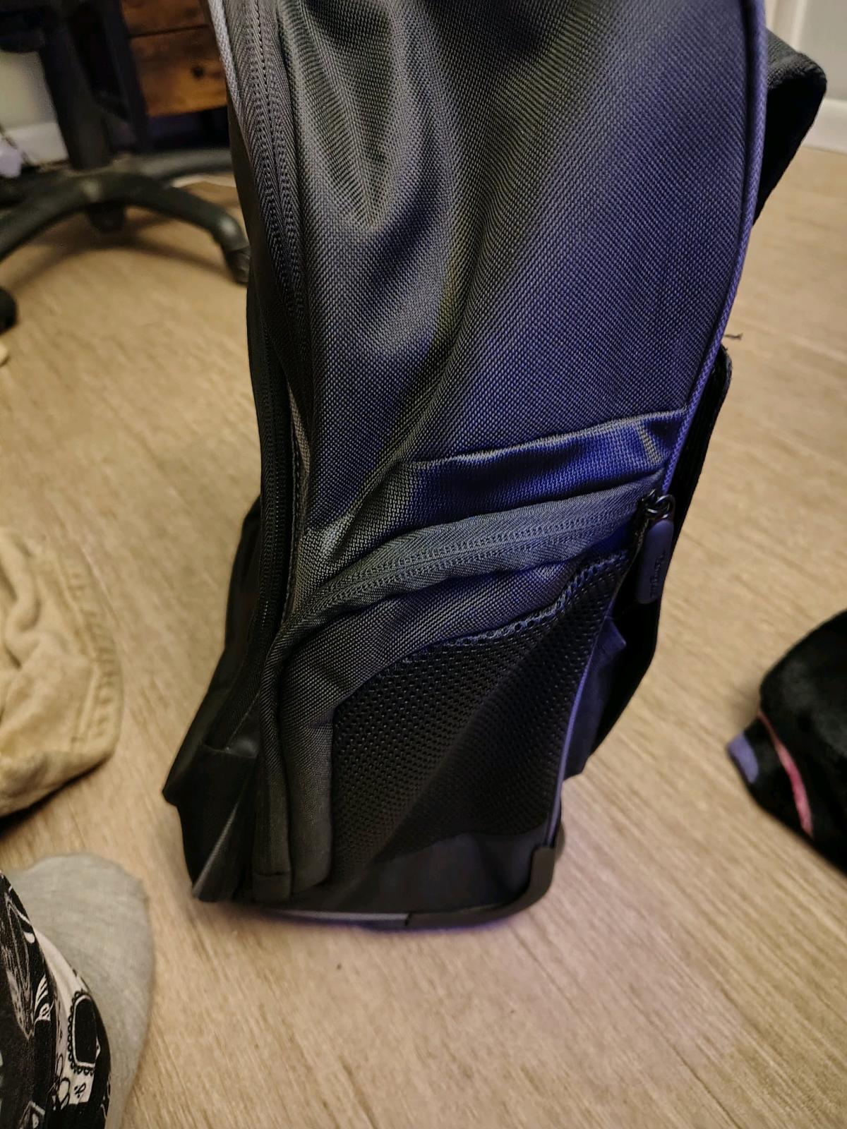 black rolling backpack and a purple non rolling backpack