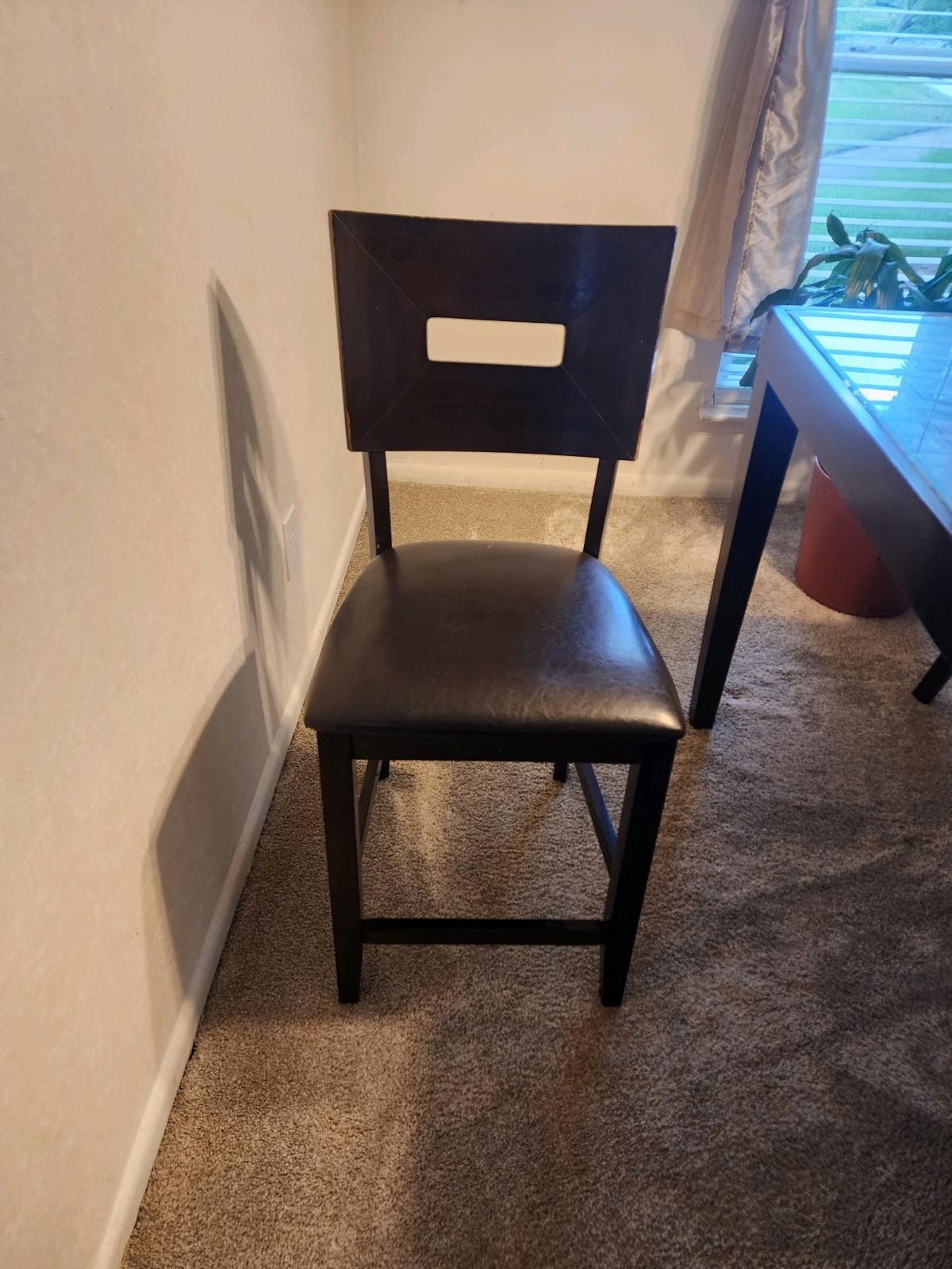 dinning table with glass top and four matching chairs