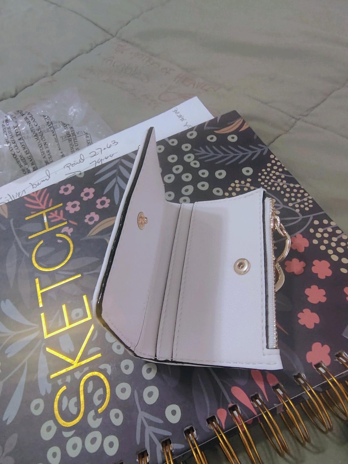 This is a white Victorias Secret foldover card case keychain