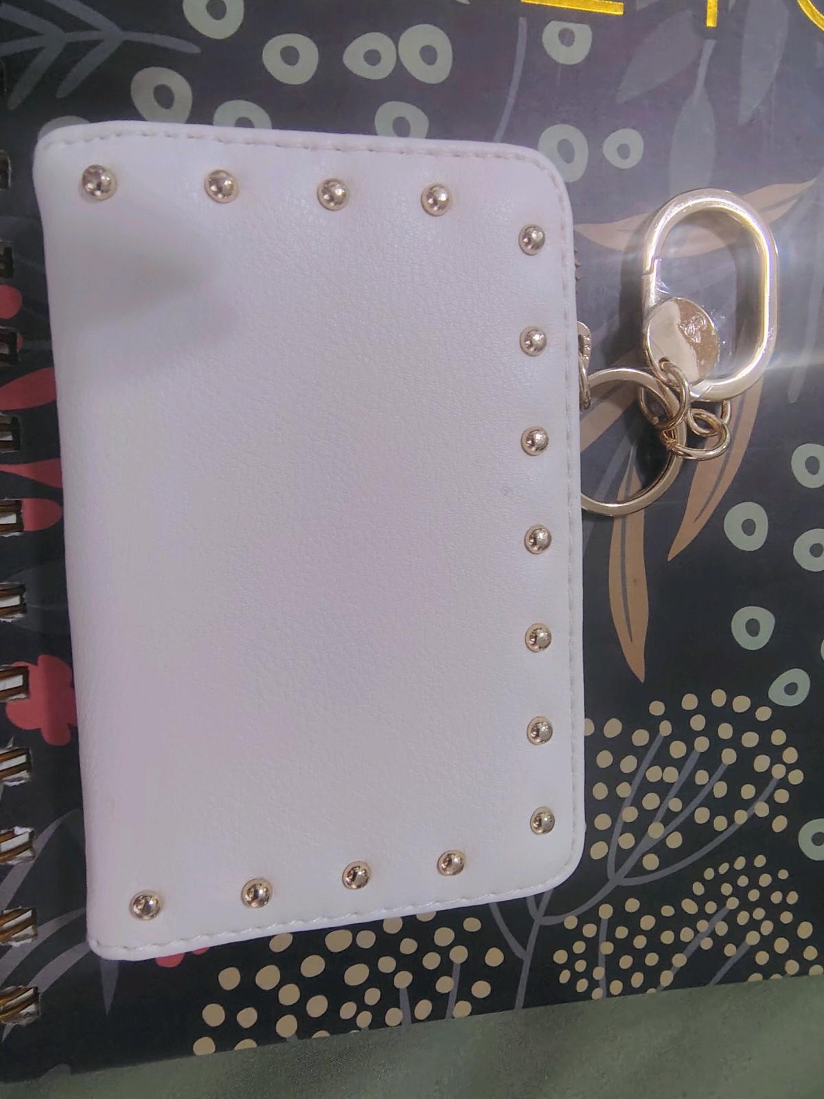 This is a white Victorias Secret foldover card case keychain