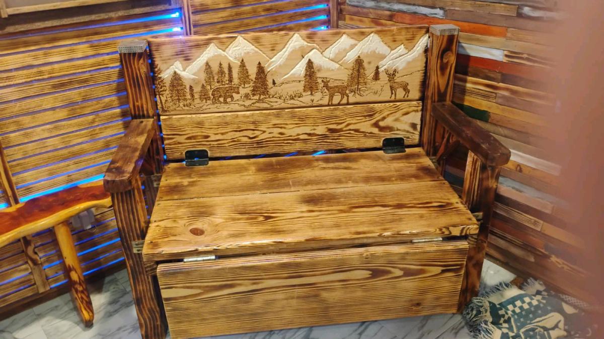 wood bench with hand carved picture on the back