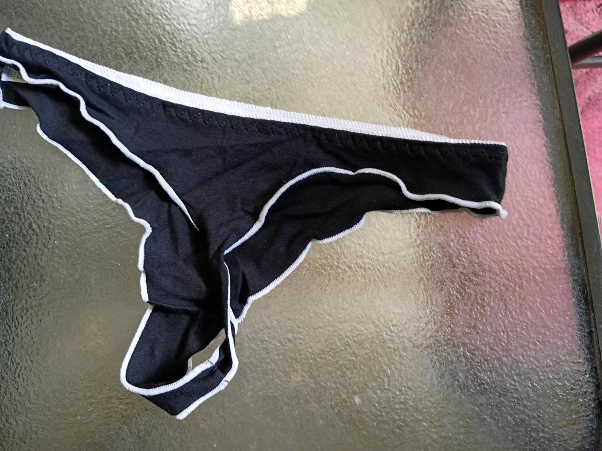 A Sexy Womans New Pair of Black and white thong panties